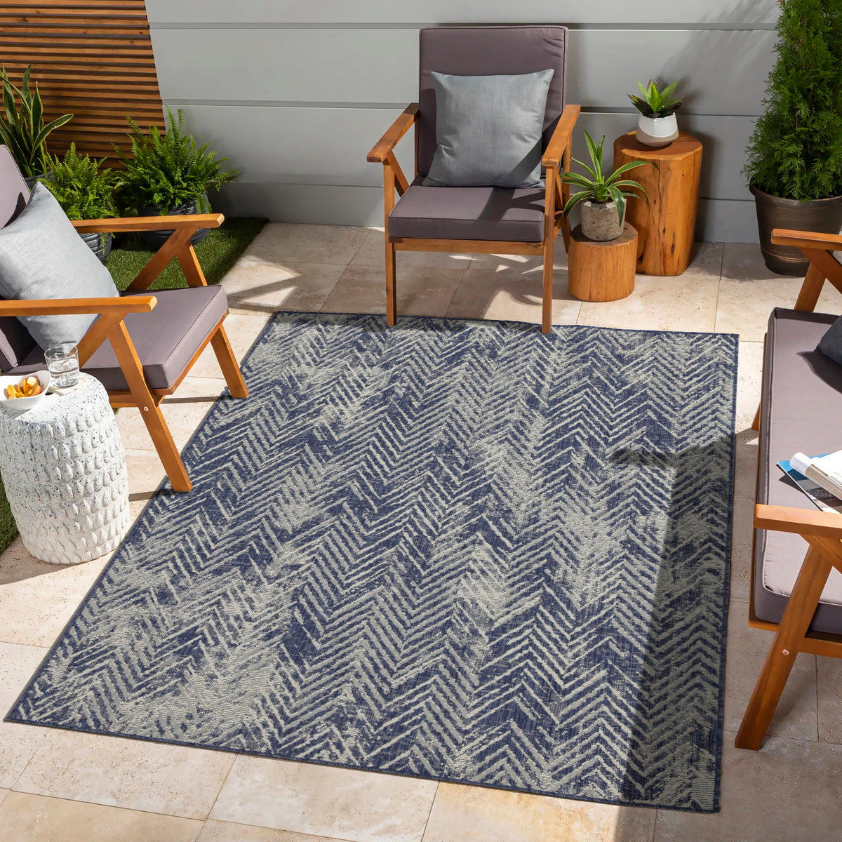 Indoor/outdoor area rug with blue and cream chevron pattern and flat surface.