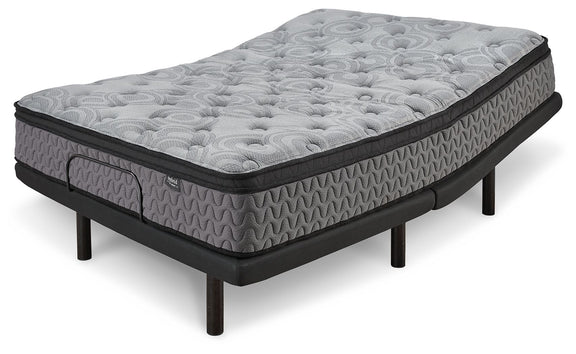 Gray firm mattress with circular quilting and textured sides, black base on legs