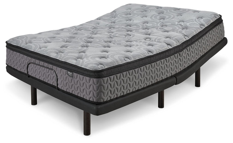 Gray firm mattress with circular quilting and textured sides, black base on legs