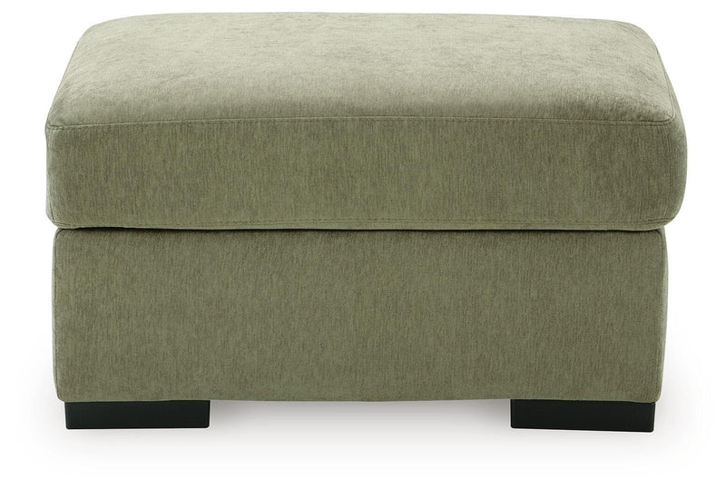 Green upholstered ottoman with rounded top and dark block feet