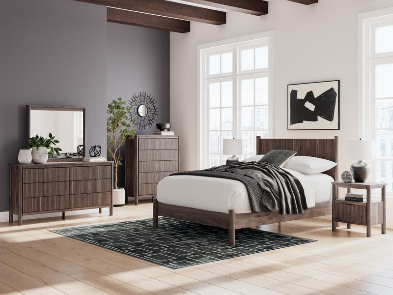 Dark brown six-drawer dresser with mirror in a modern bedroom