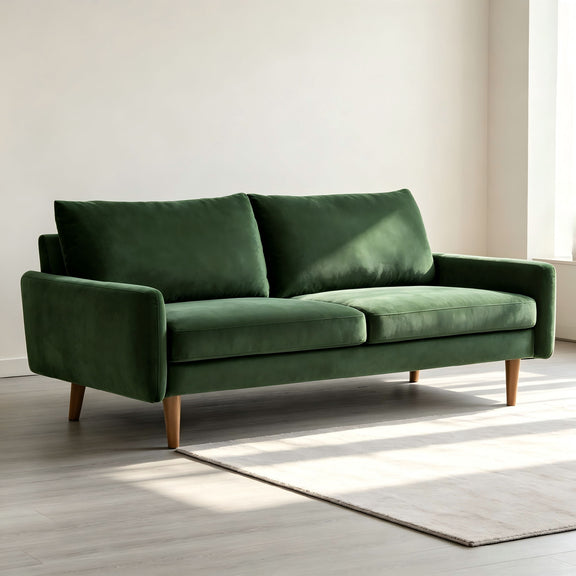 Kent sofa, dark green velvet with two seat cushions, rounded arms, and wooden legs