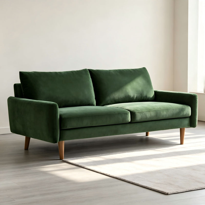 Kent sofa, dark green velvet with two seat cushions, rounded arms, and wooden legs
