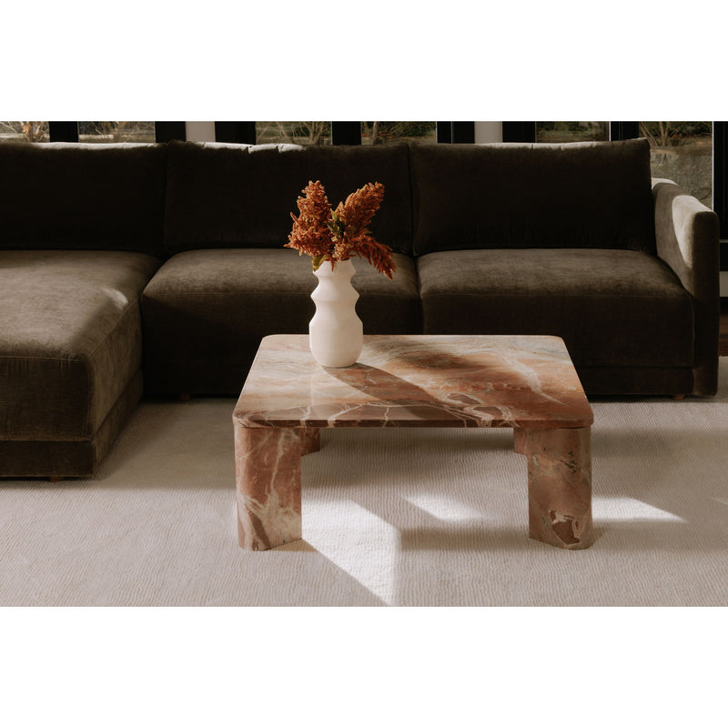 Orange marble coffee table with rectangular top and sculpted legs, vase centerpiece