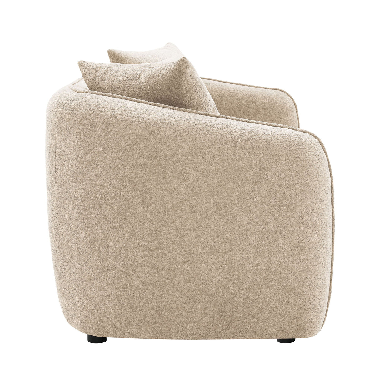 Beige upholstered armchair with rounded arms and a matching toss pillow