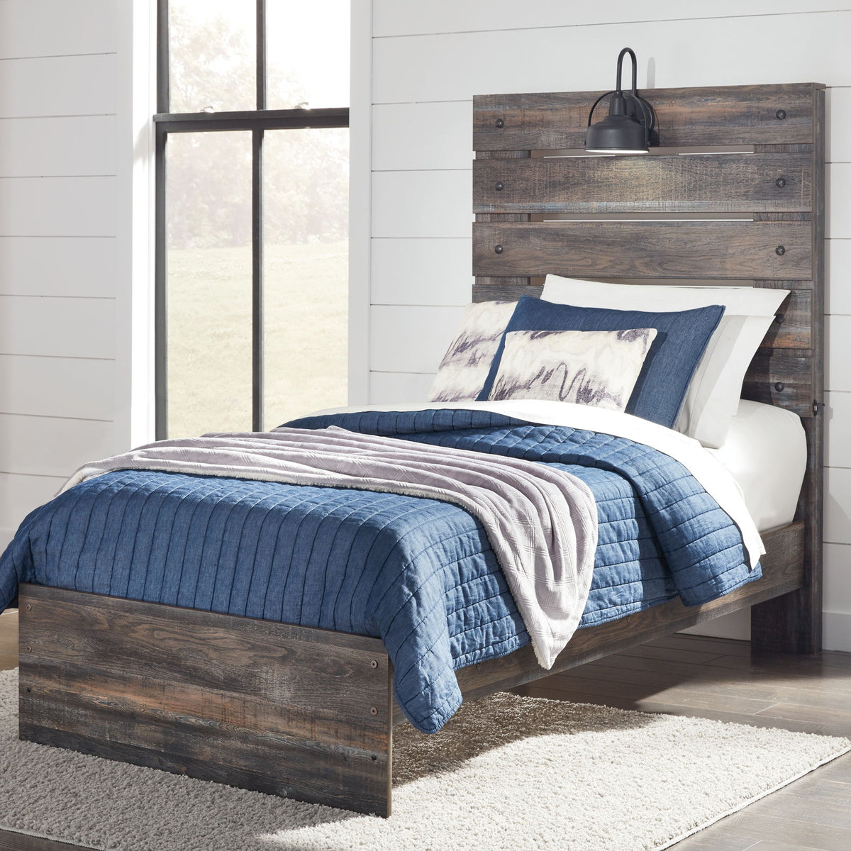 Drystan panel bed with dark wood frame and slatted headboard, styled with bedding