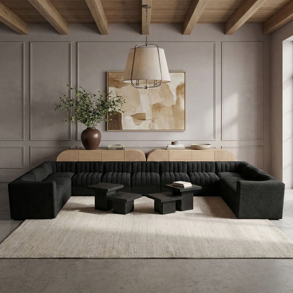 Black modular sectional sofa with tufted back cushions in a modern seating setup