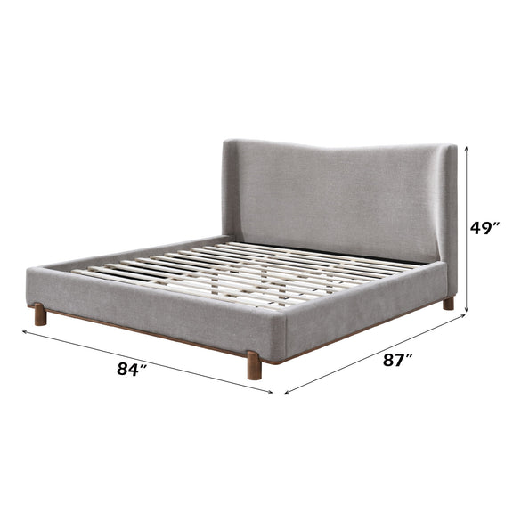Gray upholstered platform bed with tall headboard, slatted support and corner posts