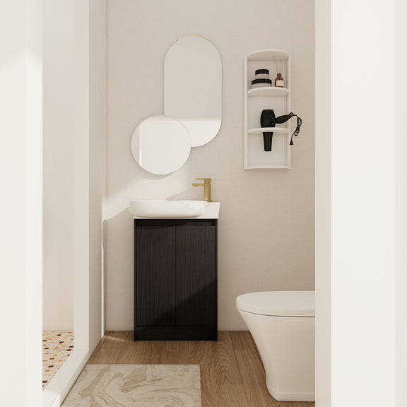 Dark brown freestanding bathroom vanity with oval sink and two cabinet doors, with small wall storage