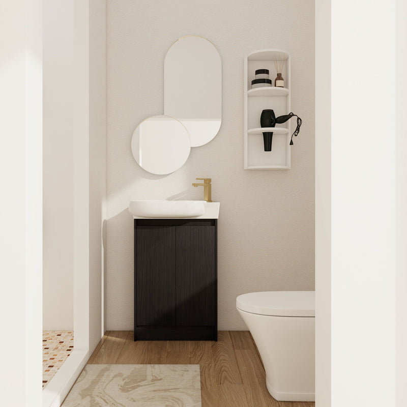 Dark brown freestanding bathroom vanity with oval sink and two cabinet doors, with small wall storage