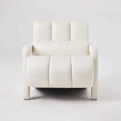 Beige upholstered accent chair with tufted back cushions and matching lumbar pillow