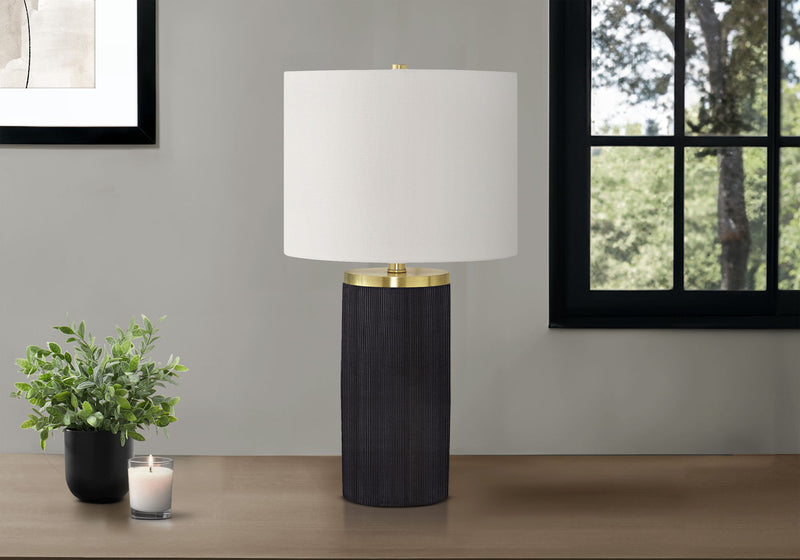 Modern table lamp: white shade, dark textured concrete base, brass accents