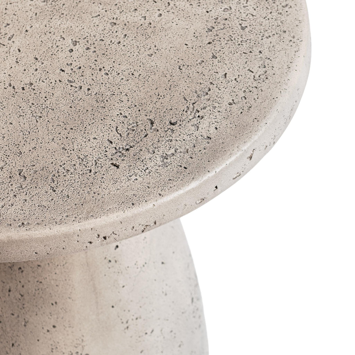 Outdoor accent table with round speckled light gray top and tapered pedestal base.