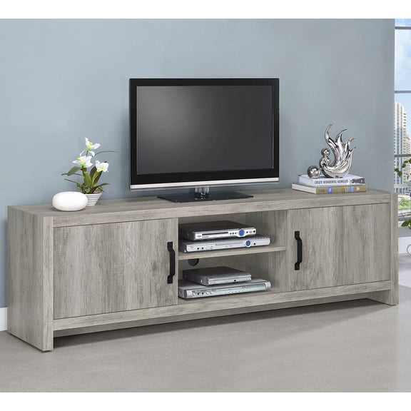 Gray TV stand with center media shelf, open compartments, and black pull handles