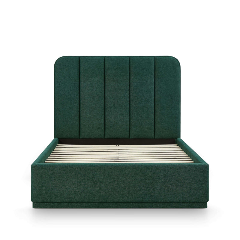 Dark green upholstered bed frame with slatted base and tall paneled headboard.
