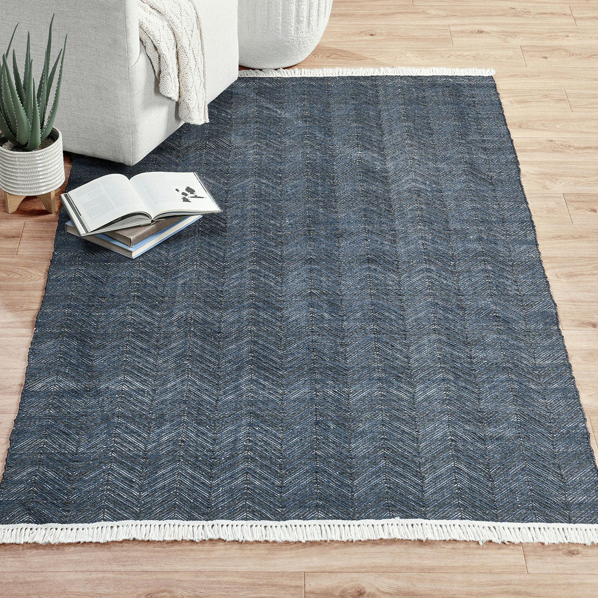 Blue chevron indoor/outdoor rug with white fringe border