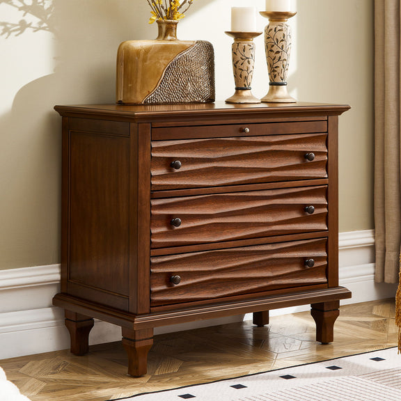 Dark brown nightstand with three sculpted drawers, shown beside a bed
