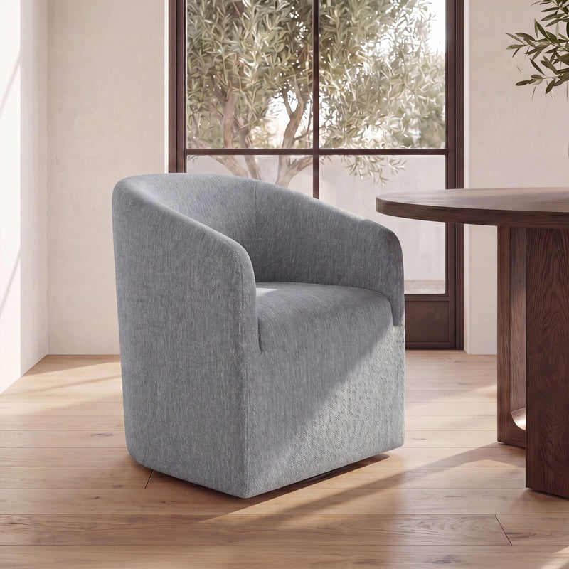 Gray upholstered dining chair, angled view, rounded arms and back