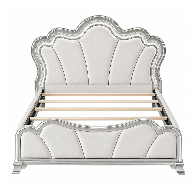 Silver upholstered platform bed with tufted panel headboard and curved footboard