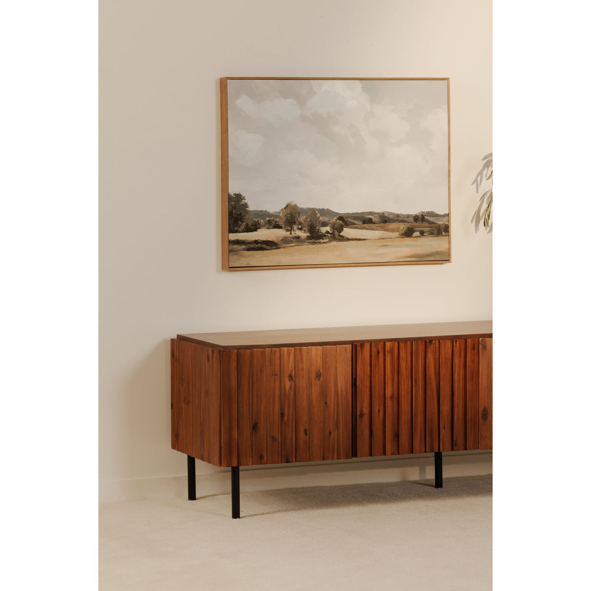 Three-quarter view of brown media cabinet with vertical wood slat doors and black legs
