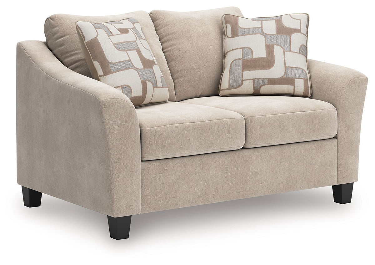 Taupe loveseat with two seat cushions, square arms, black legs, two patterned pillows