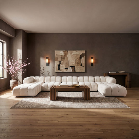 Beige modular sectional sofa with rounded back cushions and matching ottoman sections