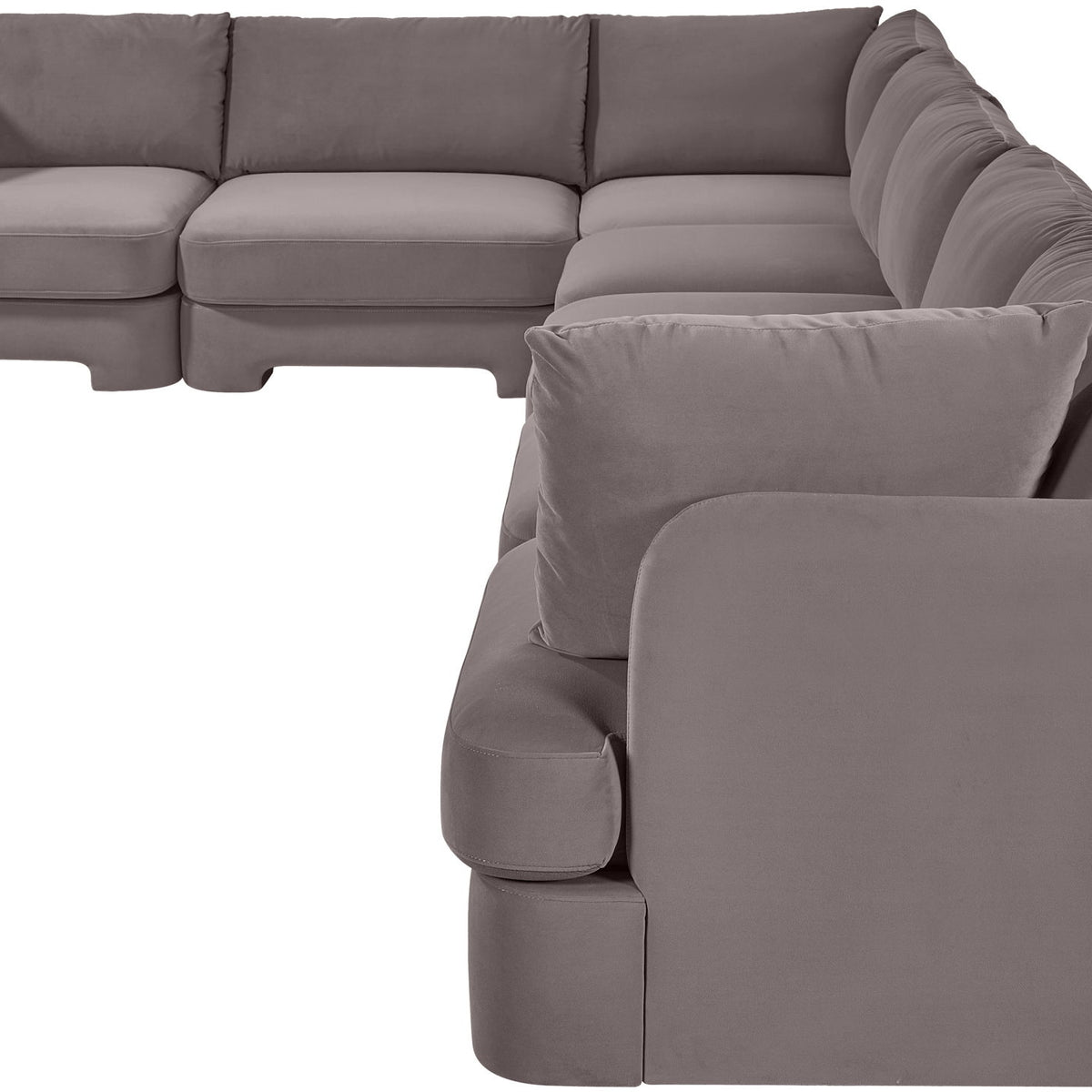 Gray velvet sectional sofa with rounded arm pads and cushioned backrest