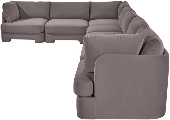 Gray velvet sectional sofa with rounded arm pads and cushioned backrest