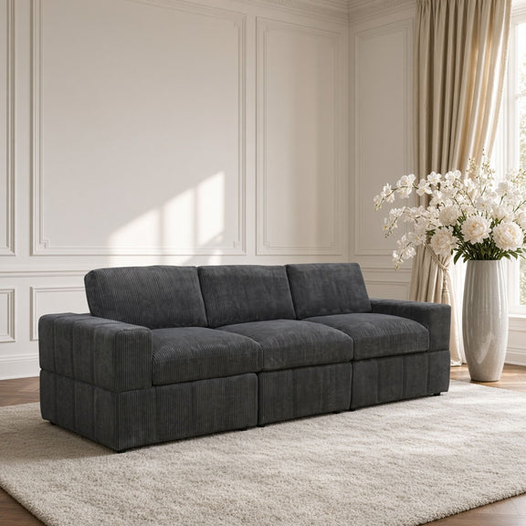 Dark gray modular sectional sofa with three seat cushions and boxy armrests