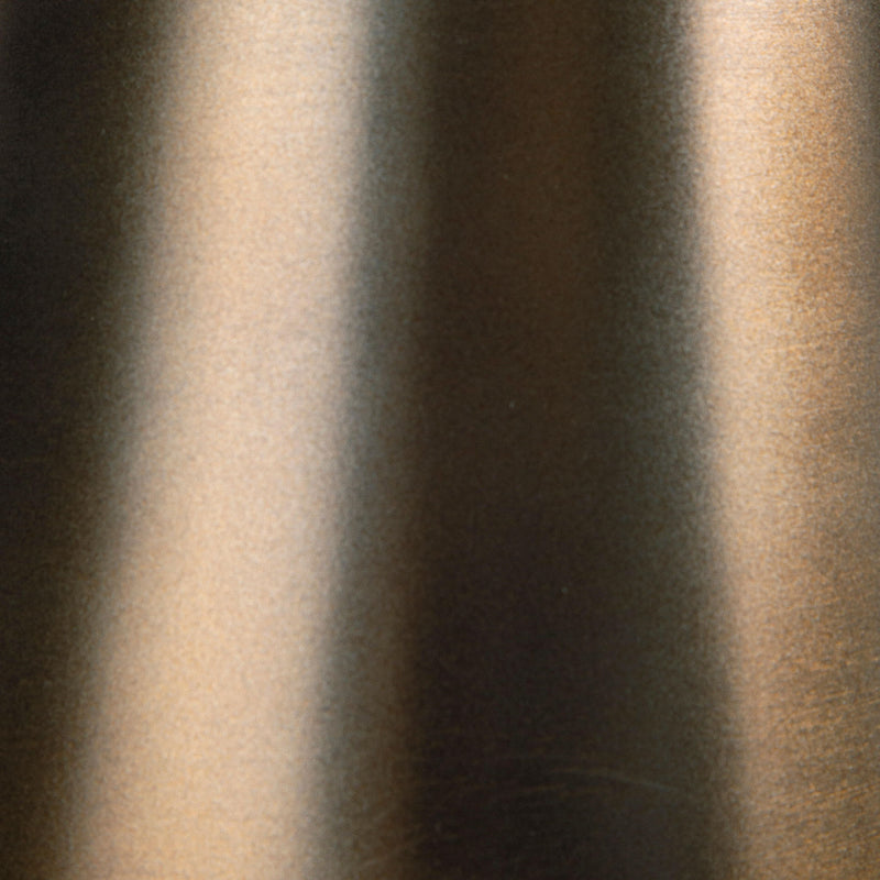 Close-up of light bronze metal finish on accent table pedestal