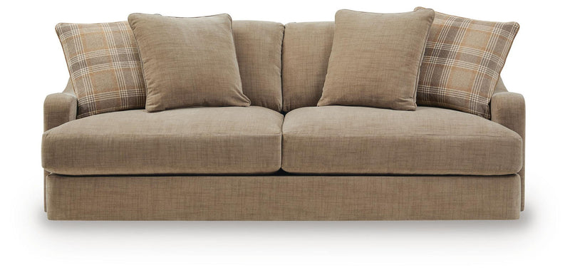 Beige fabric sofa front view with three solid and two plaid accent pillows
