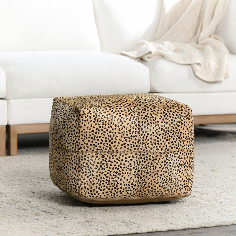 Camel leopard print hide pouf with rounded shape and low wooden base