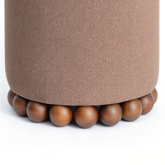 Close-up of taupe-brown ottoman top and beaded wooden base