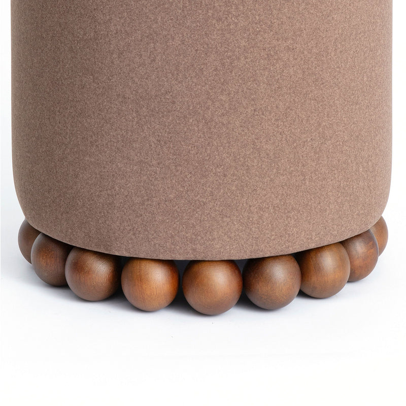 Close-up of taupe-brown ottoman top and beaded wooden base
