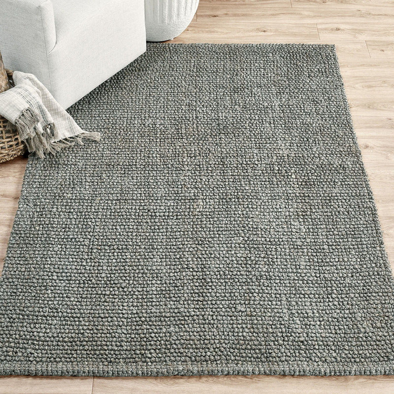 Blue-gray chunky loop rug with dense textured pile, flat woven appearance