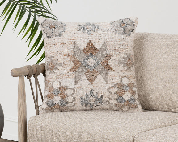 Geometric patterned square pillow with cream, gray, and clay tones