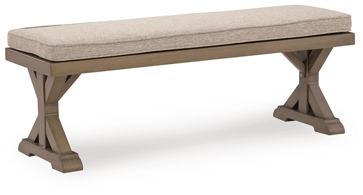 Beige upholstered bench cushion on gray wood bench with crossed side braces