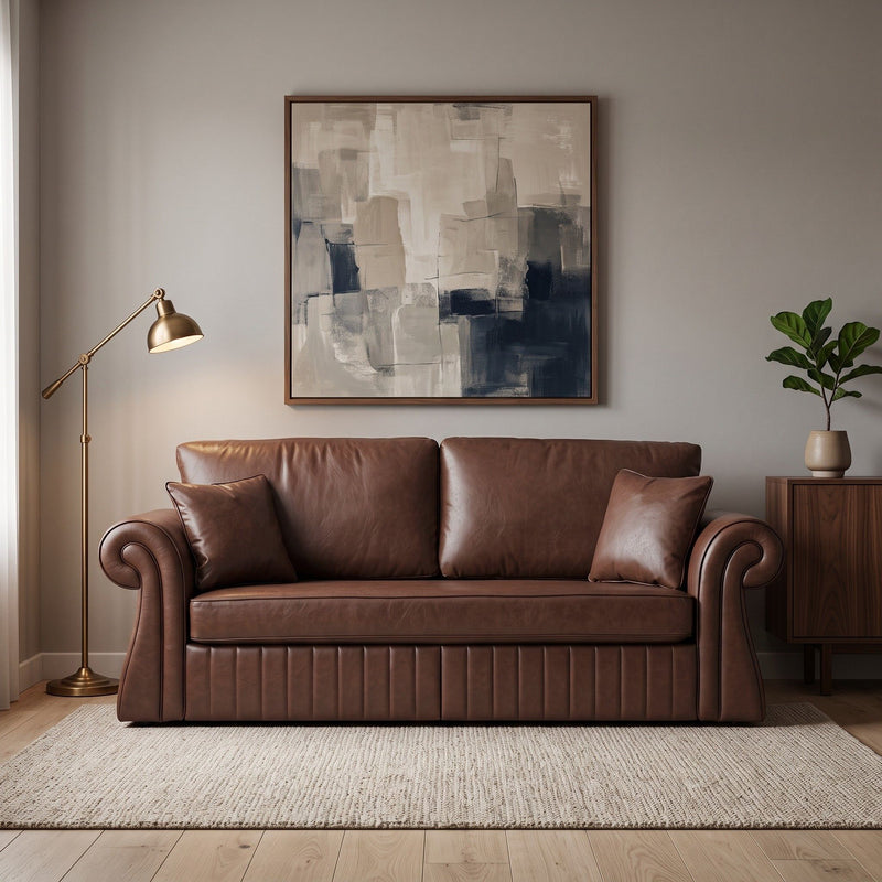 Dark brown three-seat sofa with rolled arms and two pillows, shown in a living room