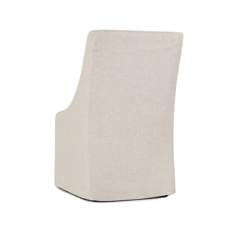 Oatmeal upholstered rolling dining chair with tall back and smooth upholstered seat.