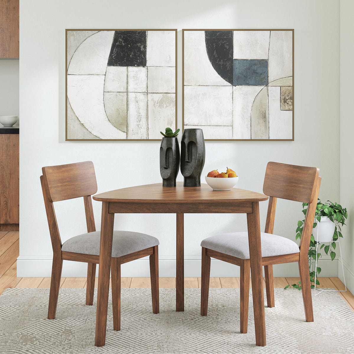 Dining table set with two brown chairs and light gray seat cushions in a room