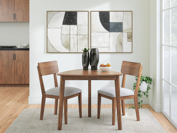 Dining table set with two brown chairs and light gray seat cushions in a room