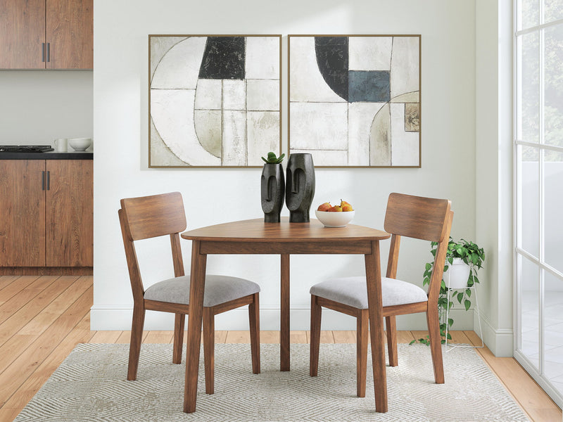 Dining table set with two brown chairs and light gray seat cushions in a room