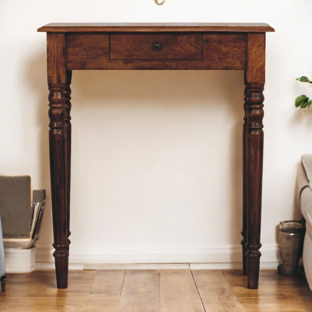 Dark brown console table with turned legs and one drawer with round knob