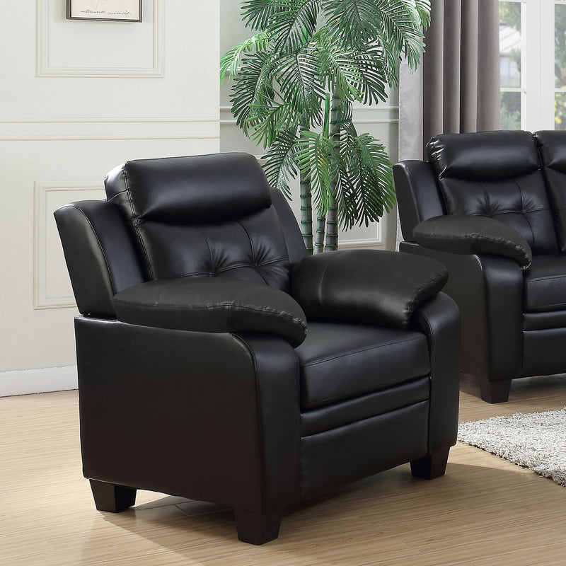 Black tufted accent chair with padded armrests and cushioned seat