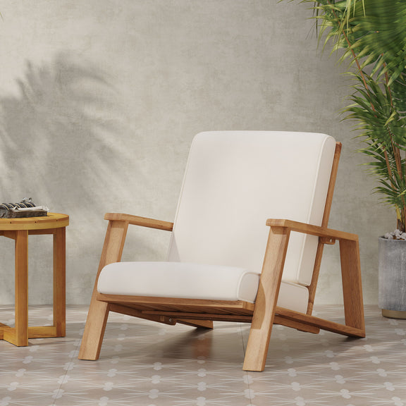 Beige padded outdoor lounge chair with light wood frame and angled armrests