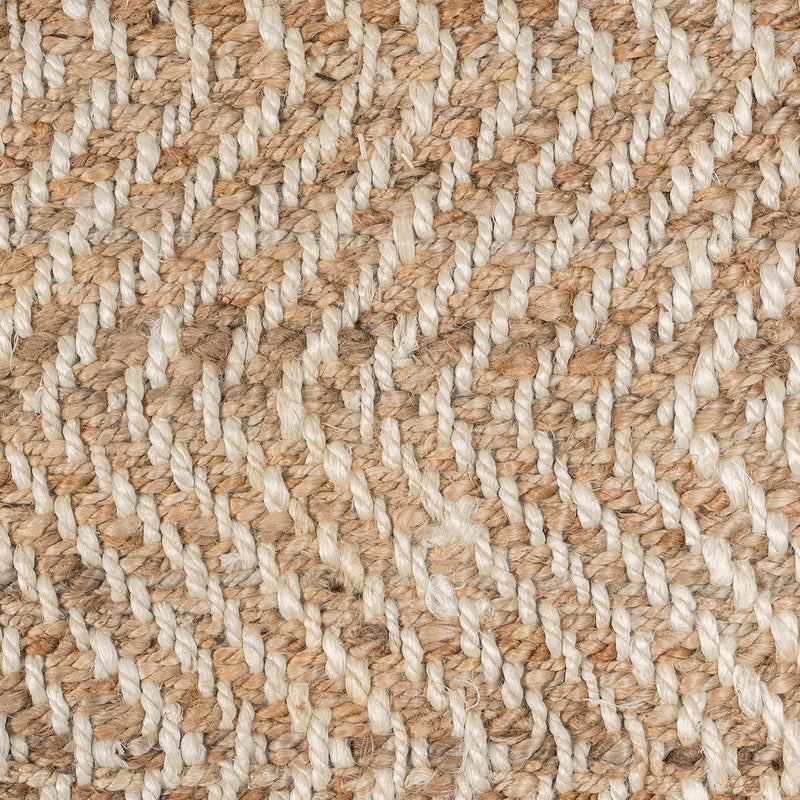 Close-up of natural jute fibers showing herringbone chevron weave texture.