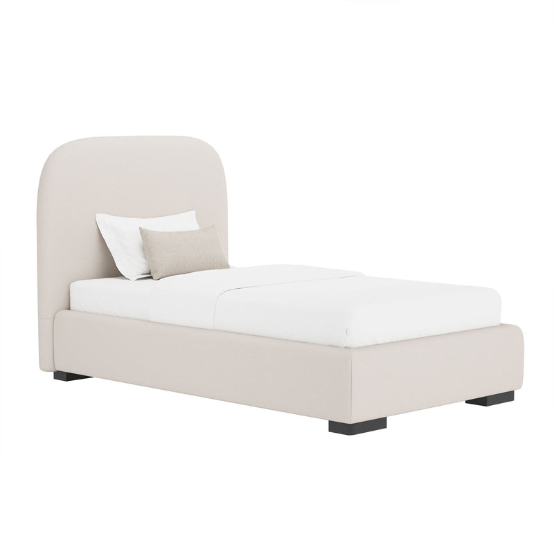 Light gray upholstered bed with rounded headboard and low footboard, with pillows