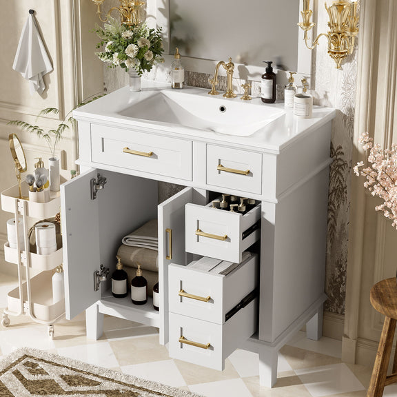 White bathroom vanity with sink, open storage cabinet, and gold drawer pulls