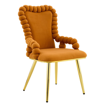 Light brown fabric dining chair with armrests, tufted bubble back, and gold legs