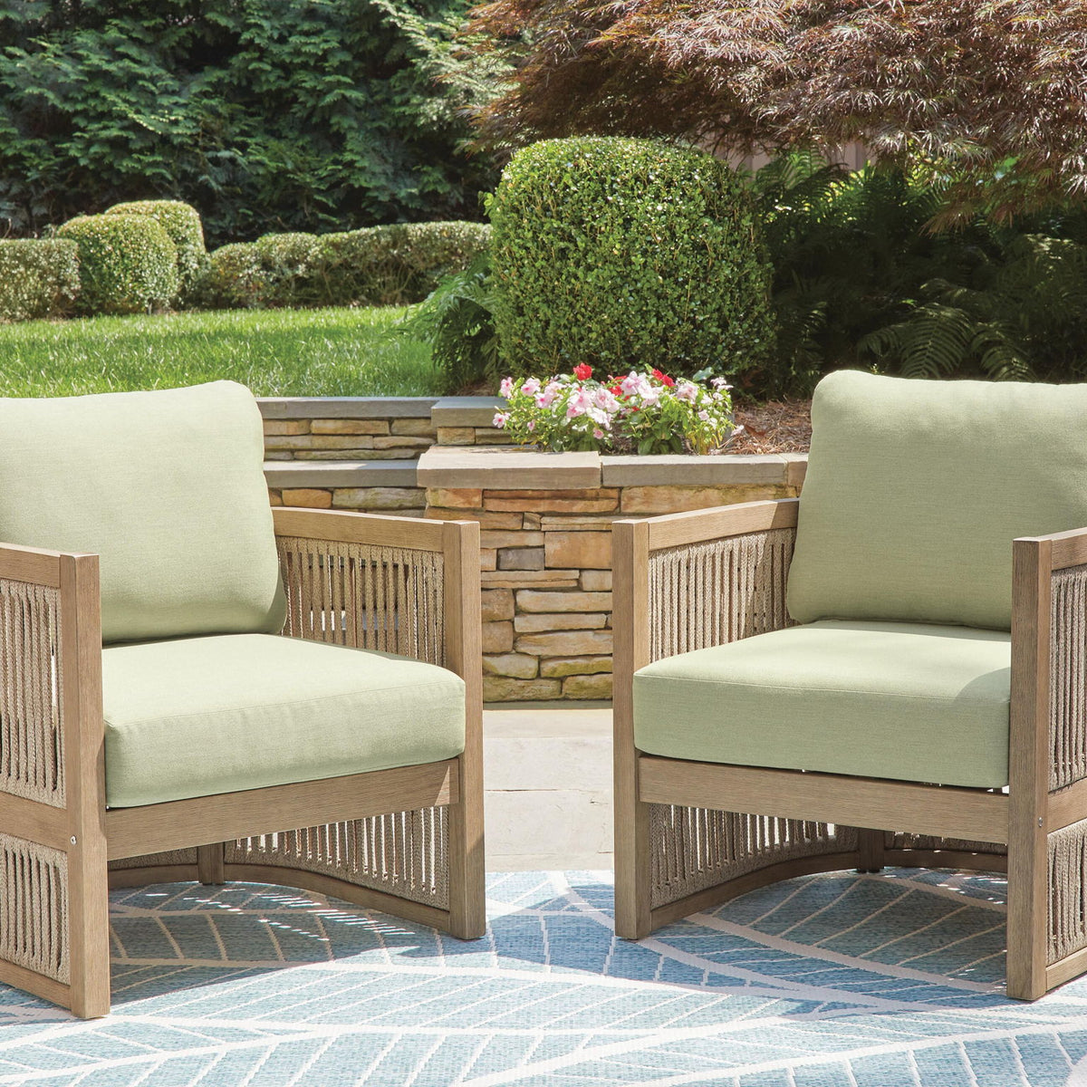 Set of 2 lounge chairs with green cushions, light wood frames for patio seating